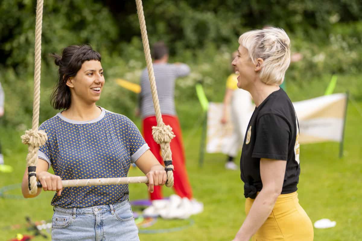 Rachael and Yasmin laughing next to trapeze
