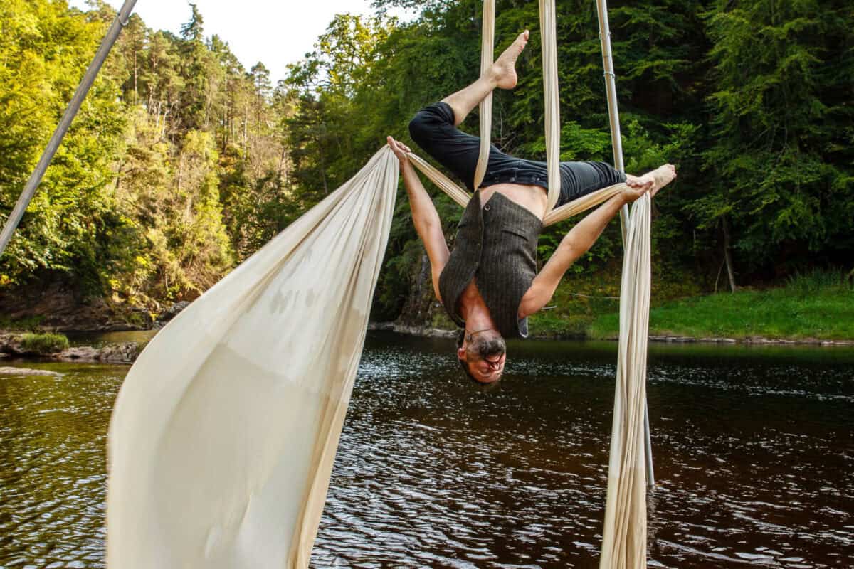 Moray Flying Circus - Ruaraidh upside down on silks over river